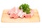 Sliced pork meat with parsley on cutting board