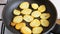 Sliced potatoes fried in a pan in sunflower oil