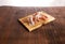 sliced prosciutto on a wooden board. pork ham on a light background. composition meat delicacy with olives and bread.