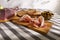 sliced prosciutto on a wooden board. pork ham on a light background. composition meat delicacy with olives and bread.