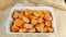 Sliced pumpkin with oil sprinkled with salt. Cooking orange baked pumpkin in white rectangular dish. Healthy vegetable, food for