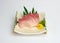Sliced raw Hamachi sashimi on plate