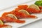Sliced red fish with lemon on a plate. Appetizing appetizer. Vitamins and healthy food. Close-up