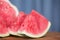 Sliced red-fleshed watermelon on table