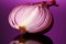 Sliced red onion exhibits translucent layers on a pink purple reflection