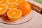 sliced ripe appetizing orange on a cutting board on a green table