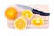 Sliced ripe appetizing orange on a cutting board next to a knife