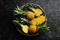 Sliced ripe baby pineapple on a black stone background. Tropical fruits.