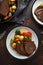 Sliced Roast beef with honey glazed vegetables, served on plate. festive dinner