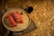 Sliced salmon placing on wooden plate together wasabi radish and shoyu on burlap table by top view