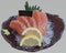 Sliced Salmon sashimi on black plate divided. Fatty raw fish slices Isolated, Good Japanese Menu.