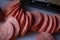 Sliced sausages on chopping board. Sliced sausage on the board