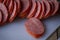 Sliced sausages on chopping board. Sliced sausage on the board