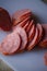 Sliced sausages on chopping board. Sliced sausage on the board