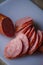 Sliced sausages on chopping board. Sliced sausage on the board