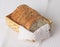 Sliced sesame bread in bamboo basket on white cloth