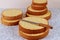 Sliced sponge cake with knife on table for making wedding cake