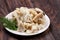 Sliced squid on a plate on a dark wooden background