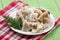 Sliced squid on a plate on a green wooden background