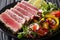 Sliced Steak of tuna in sesame and a salad of fresh vegetables c