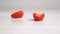 Sliced strawberry fall on white surface