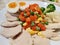 Sliced Streamed organic chicken breast serving with sliced medium boiled egg and various vegetables corn carrot peas Broccoli