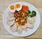 Sliced Streamed organic chicken breast serving with sliced medium boiled egg and various vegetables corn carrot peas Broccoli