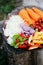 Sliced summer vegetables on a stump