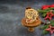 Sliced traditional Scottish Christmas Dundee fruit cake with dried fruit mix, garnished with peeled almonds on a wooden board