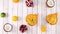 Sliced tropic and citrus fruits appear on light wooden theme. Stop motion