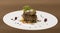 Sliced truffles topped on a grilled steak,  beef and pork,  with vegetable and sauce,  on a white plate,  brown background