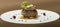 Sliced truffles topped on a grilled steak,  beef and pork,  with vegetable and sauce,  on a white plate,  brown background