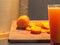 Sliced tubers and carrot juice Daucus carota on neutral background