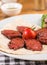 Sliced Turkish sausage on â€‹â€‹white plate cooked on the grill