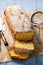 Sliced vanilla pound cake on wooden background.