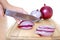 Sliced violet onion on cutting board