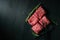 Sliced wagyu marbled beef for yakiniku on plate on black background, Premium Japanese meat