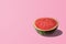 Sliced watermelon on pastel pink background. Minimal fruit concep