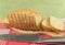 Sliced wheat bread on cutting Board closeup. Knife, red napkin