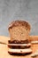 Sliced wheat rye bread on a cutting board. Whole grain bread with seeds. Naturally fermented homemade healthy bread