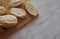 Sliced white bread lies on a cutting board. Buttered bread lies on a wooden cutting board. selectiv focus