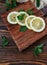 sliced and whole lemon on wooden chopping Board