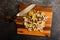 Sliced Wild Mushrooms with a Chef\\\'s Knife on a Wooden Cutting Board