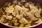 Sliced wild mushrooms in a frying pan.