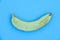 Sliced yellow fruit. A half banana on a blue background