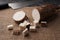 Sliced yucca root on a sackcloth on a black wooden table with a knife