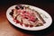 Sliced â€â€¹â€â€¹herring with onions on a white plate