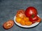 Sliced â€‹â€‹juicy tomatoes of different varieties on a plate. Greenhouse orange tomatoes. Healthy food. Still life of