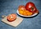 Sliced â€‹â€‹juicy tomatoes of different varieties on a plate. Greenhouse orange tomatoes. Healthy food. Still life of vegetables