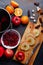 Slices of apples on a board, dates, near a plate with cranberries and a pan with compote. View from above.